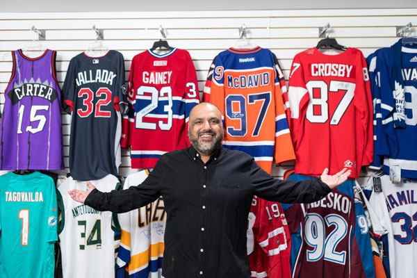 eBay seller in front of his sportswear collections