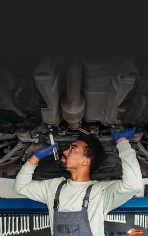 A mechanic inspecting a car