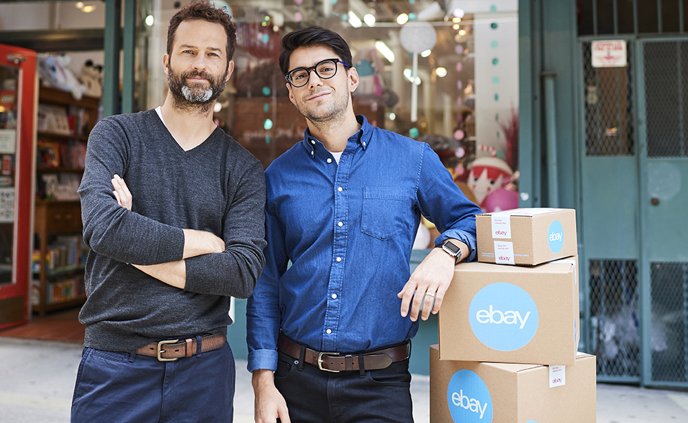 Two people standing by eBay boxes