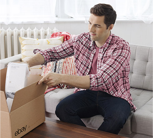 Man packing product into an eBay box