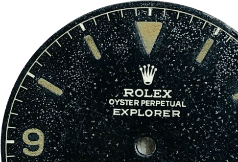A black Rolex watch face with gold accents.