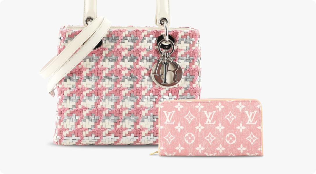 A pink and grey tweed Christian Dior back sitting slightly behind a pink and white Louis Vuitton-printed wallet. Both against a white background.