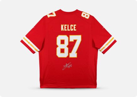 A signed Travis Kelce Kansas City Chiefs jersey against an off-white background.