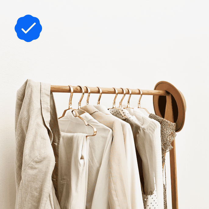 A rack with white clothes on hangers