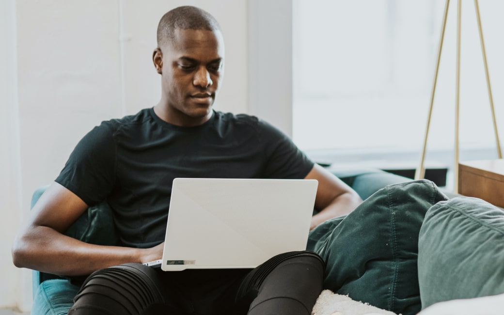 Person sitting in chair, working on laptop