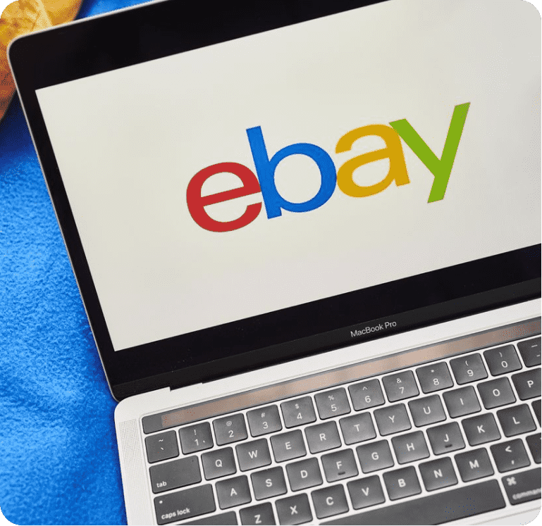 A laptop with the eBay logo on the screen. 