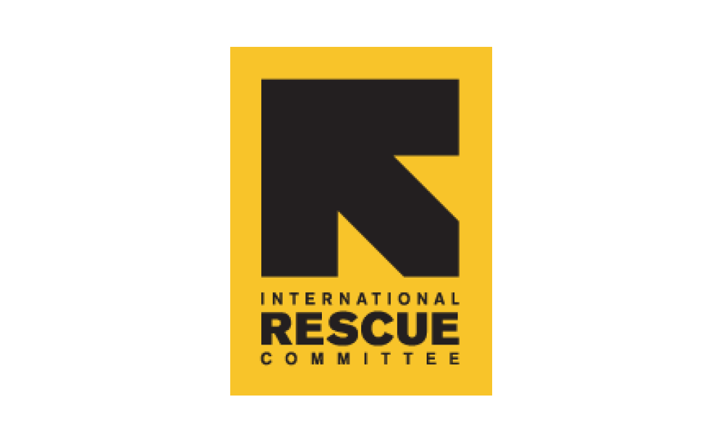 The International Rescue Committee logo - A yellow block with a large black arrow pointing to the top left and the text International Rescue Committee in black under the arrow. The yellow block is on a white rectangular box.