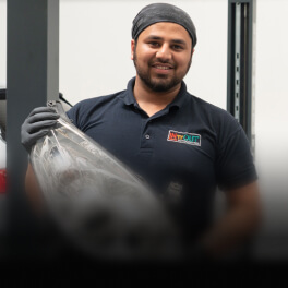 Car operator with vehicle parts in his hands