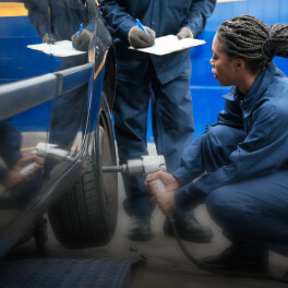 Woman installing tyres in a car