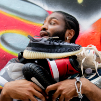 Man holding sneakers