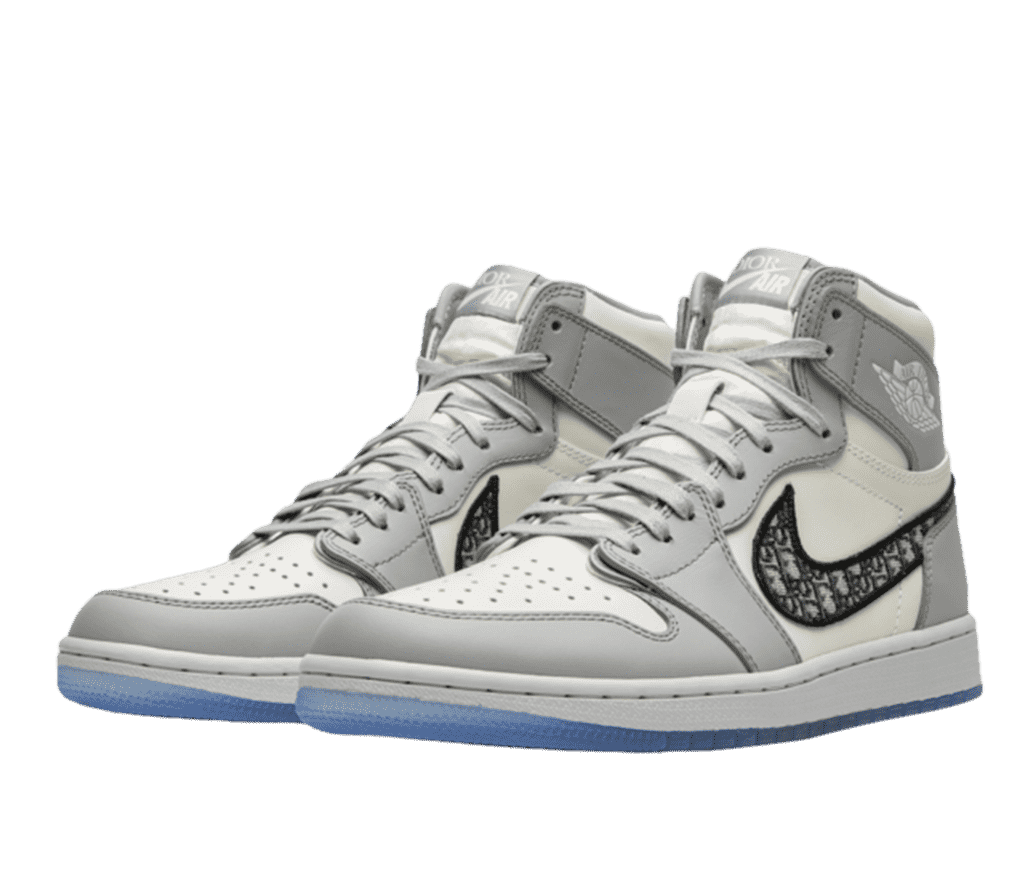 Front right angled view of a pair of Air Jordan Dior 1s. The soles are light powder blue and the shoe is light grey and white toned with the Dior logo in the swoosh and on the tongue.