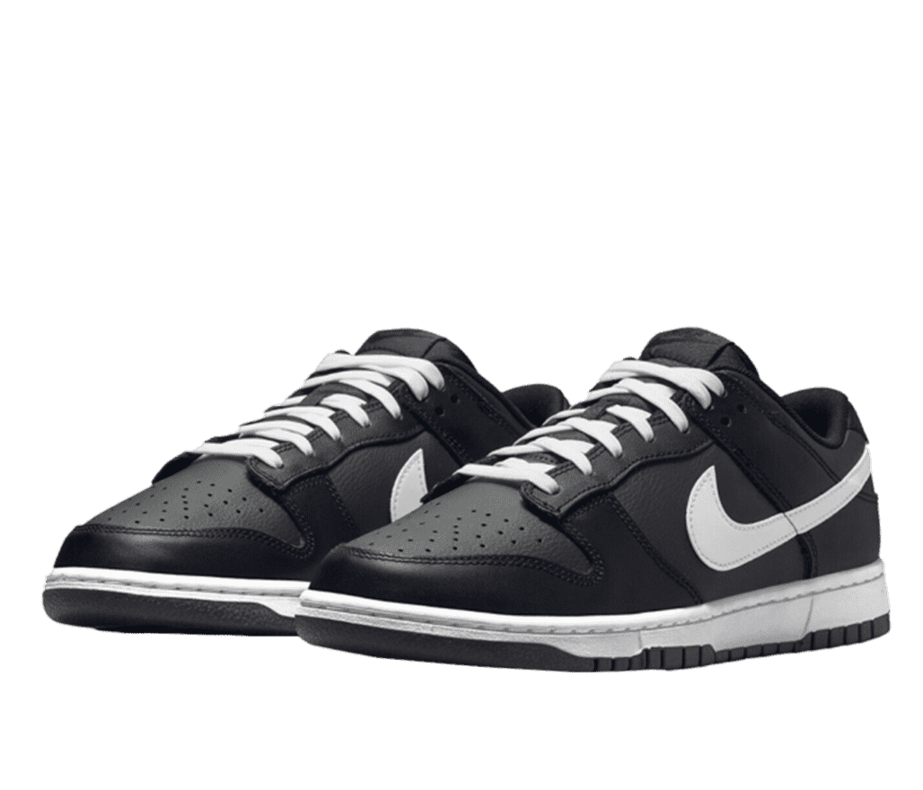 Front right angled view of a pair of black leather Nike low top sneakers. The swoosh, laces, and sole are white.