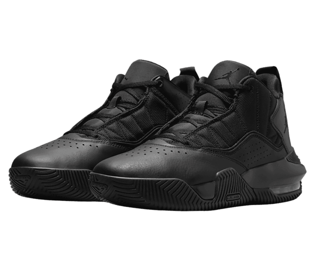 A pair of Jordan Stay Loyal sneakers in all-black and protruding soles on the lateral sides.