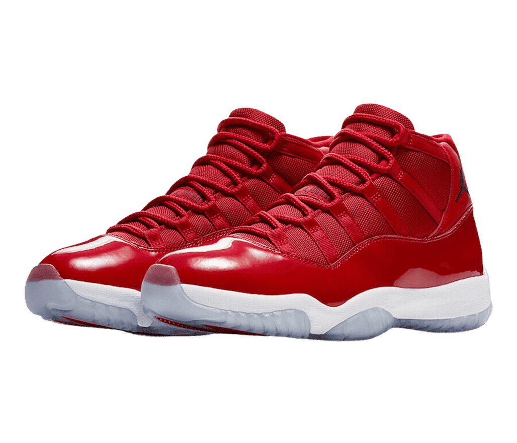 A pair of AJ11 “Win Like 96” sneakers in red uppers, white midsoles, and light gray semi-translucent outsoles.