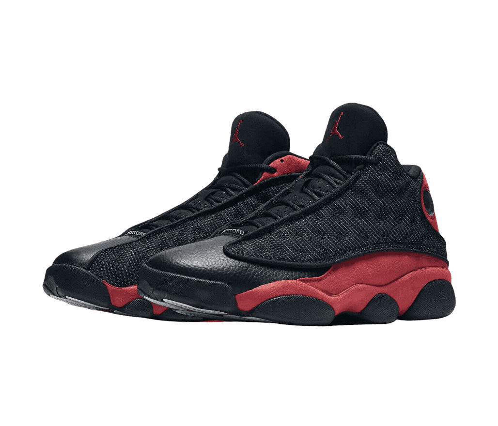 A black pair of AJ13 “Bred” sneakers with red suede quarters, black leather toeboxes, and black fabric vamps with polka-dotted embroidery.