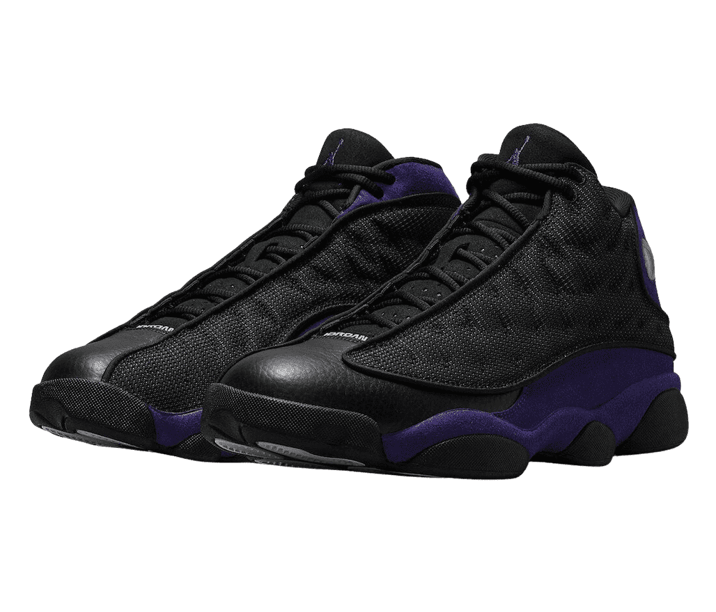A black pair of AJ13 “Court Purple” sneakers with purple suede quarters, black leather toeboxes, and black fabric vamps.