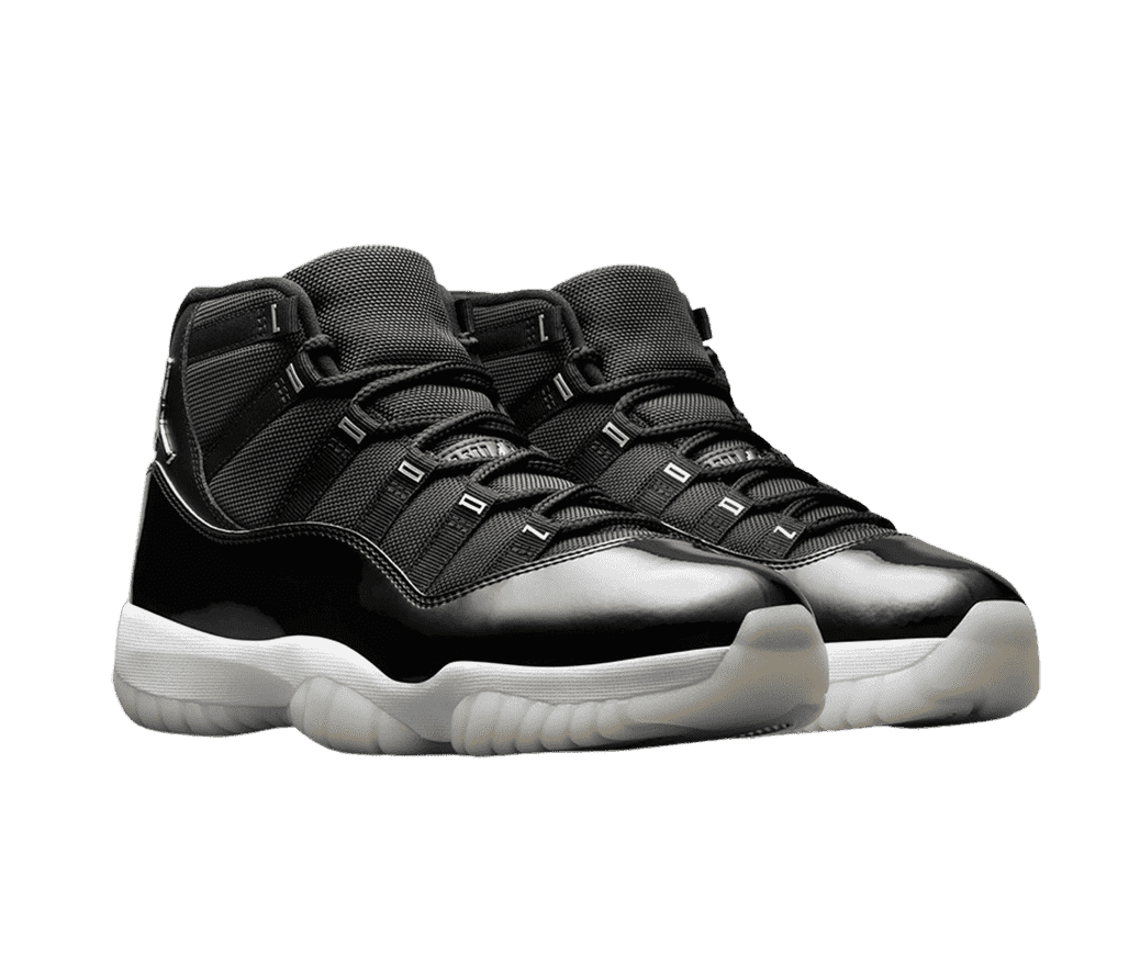 A black pair of AJ11 “Jubilee” sneakers in patent leather and canvas, white midsoles, chrome Jordan logos under the collar, and off-white semi-translucent outsoles.