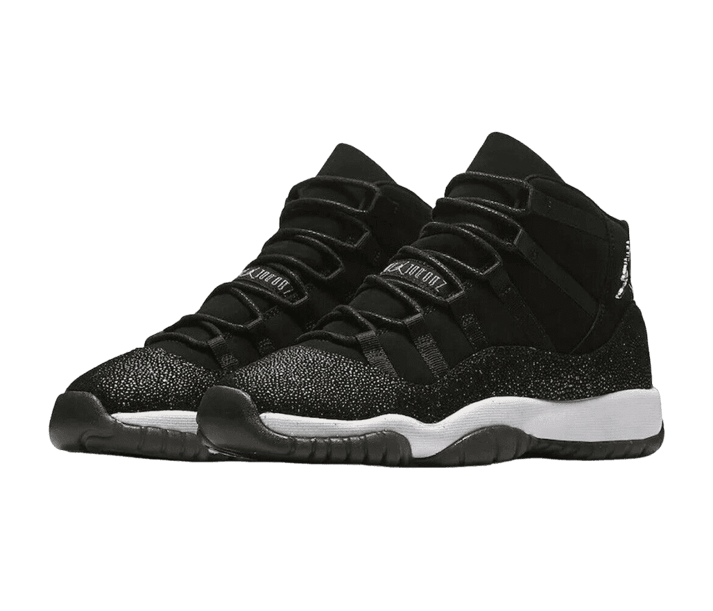 A black pair of AJ11 “Heiress” sneakers with white midsoles, stingray leather mudguards, and a chrome Jumpman logo under the collar.