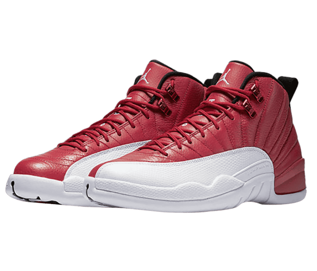 A red pair of AJ12 “Gym Red” sneakers with leather uppers, white soles and mudguards, and red shiny lace locks.
