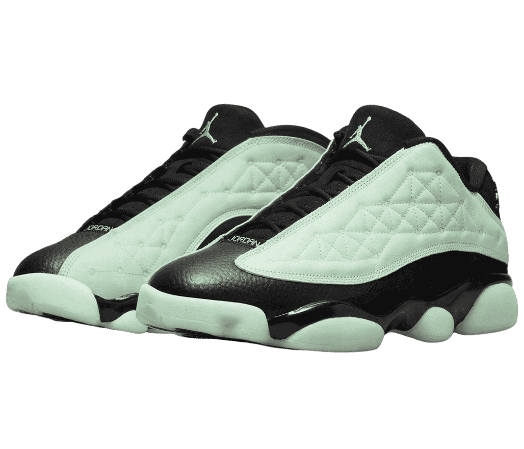 A pair of AJ13 “Singles Day” sneakers with black leather uppers and mint vamps, outsoles, and Jumpman logos on the tongue.