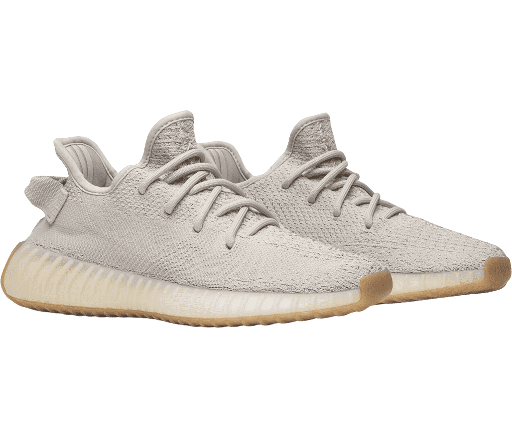 A pair of Adidas Yeezy Boost 350 V2 “Sesame” sneakers with light gray uppers, off-white midsoles, and yellow gum outsoles.