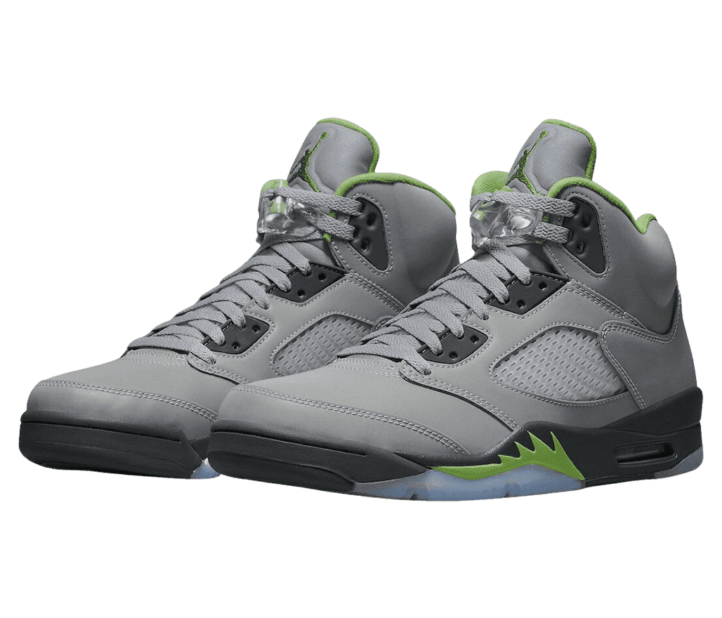 A gray pair of AJ5 “Green Bean” sneakers with clear lace locks and black soles with teal details.