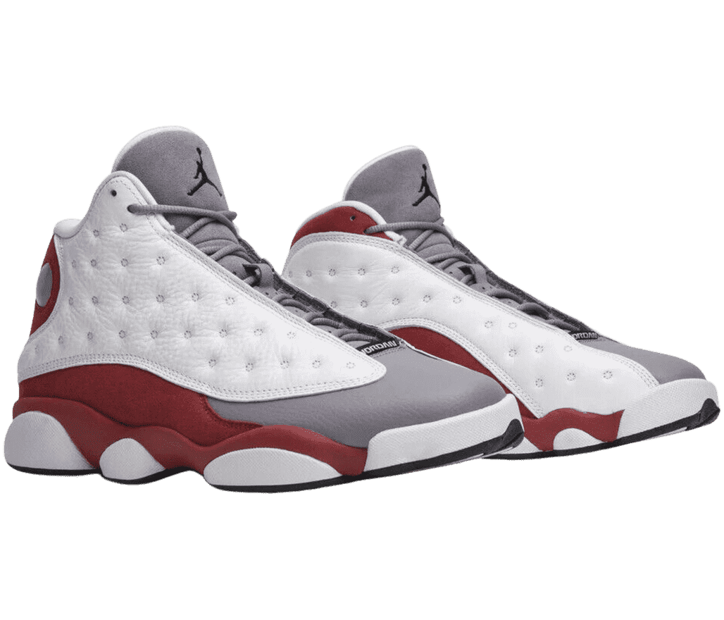 A pair of AJ13 “Grey Toe” sneakers with red suede quarters, gray tongue and toeboxes, and white vamps.