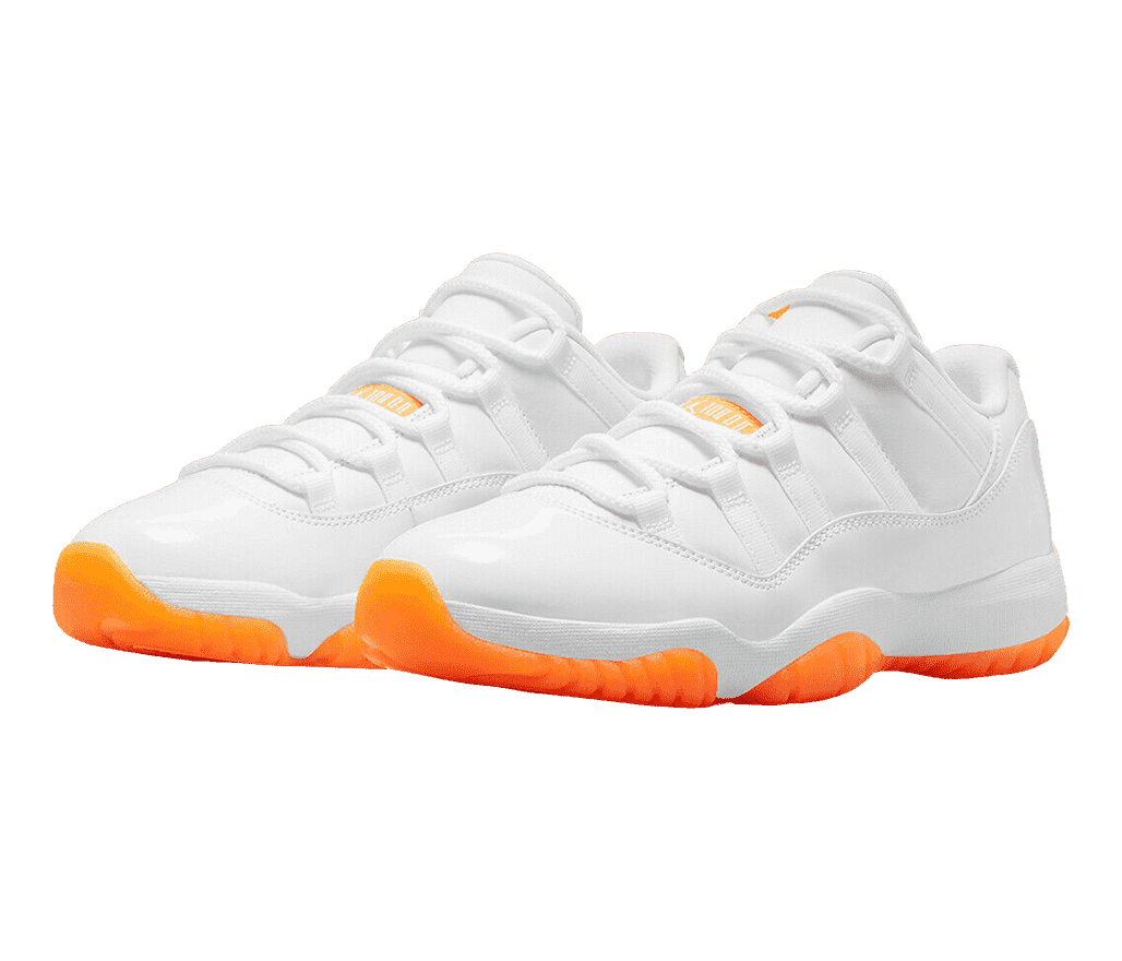 An all-white pair of AJ11 Low “Citrus” sneakers with bright orange outsoles.