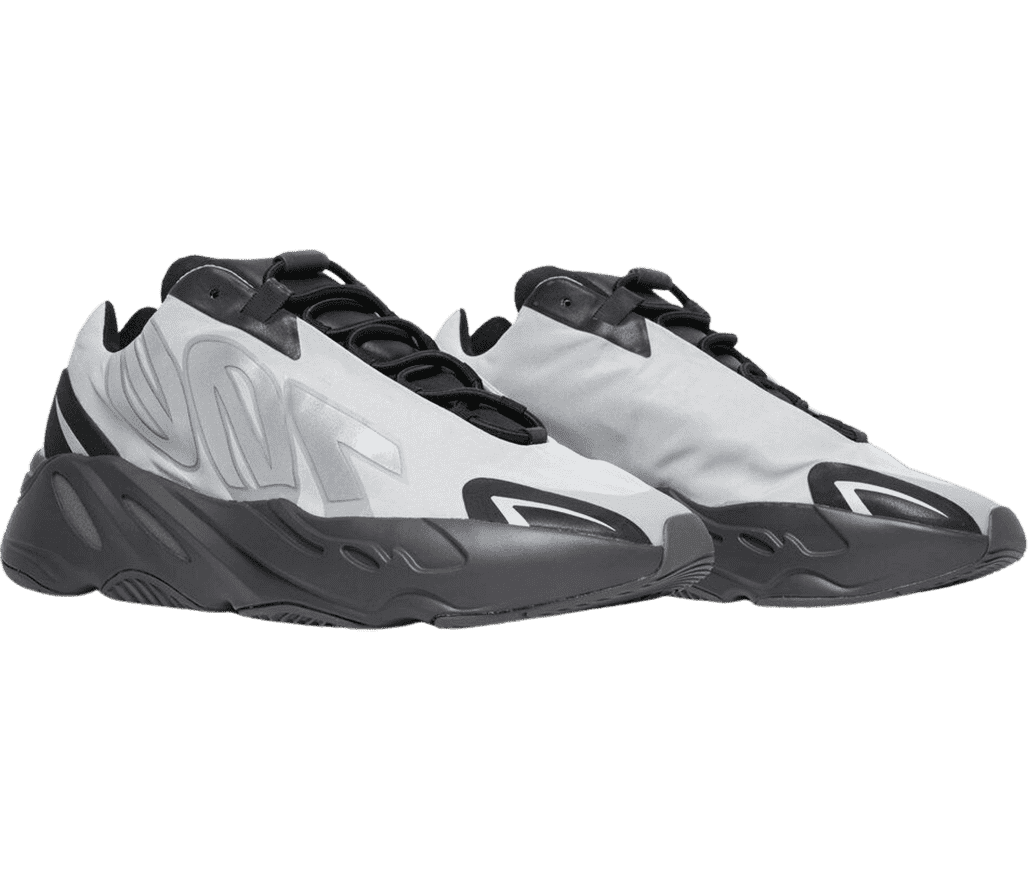 A pair of Yeezy Boost 700 MNVN sneakers in white nylon uppers with black rubber soles and tongues.
