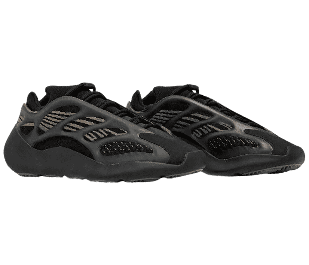 A black pair of Yeezy Boost 700 V3 “Clay Brown” sneakers with mesh uppers, peach stripes on the sides, and rubber cages.