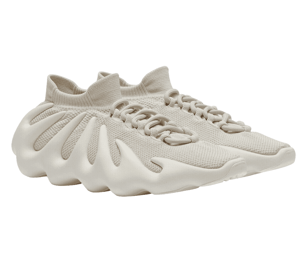 A pair of Yeezy 450 “Cloud White” sneakers in off-white mesh uppers with a cuffed collar and wavy white rubber soles.