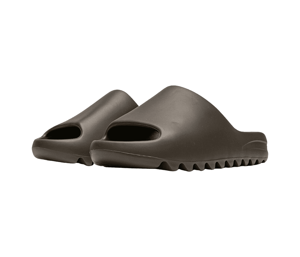 A pair of YEEZY slides in black made in a one-piece mold made entirely from EVA foam.