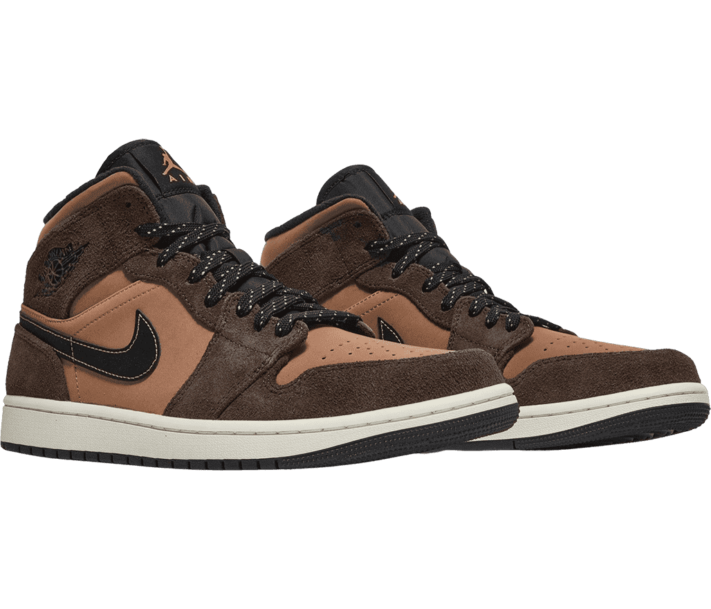A pair of AJ1 Mid sneakers with light brown short suede uppers and dark brown overlays in a longer suede.