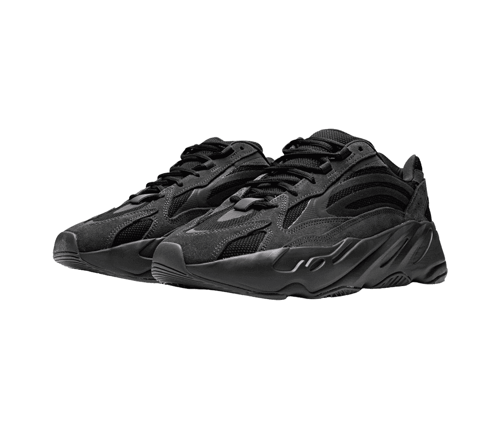 A pair of YEEZY 700 V2 in full black with stitched patterns on the laces, cover, and semi-translucent siding.