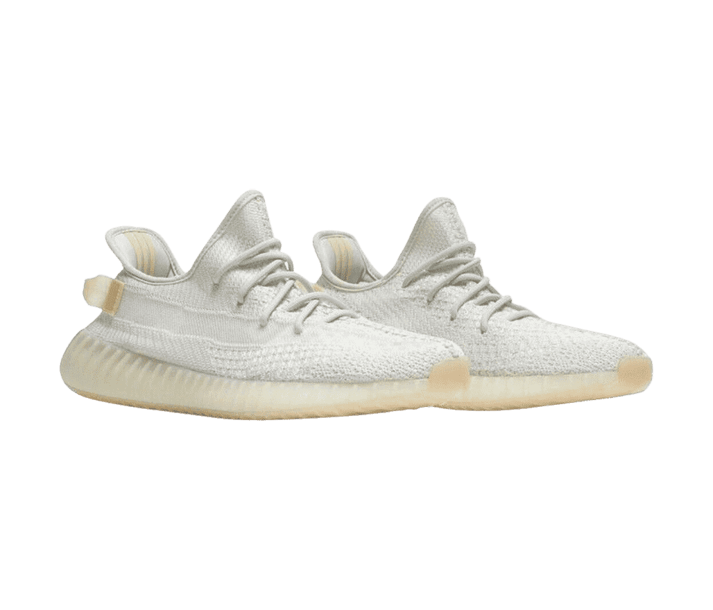 A pair of YEEZY 'Light' sneakers with white canvas cotton for the whole shoe and a semi-translucent boosted sole.