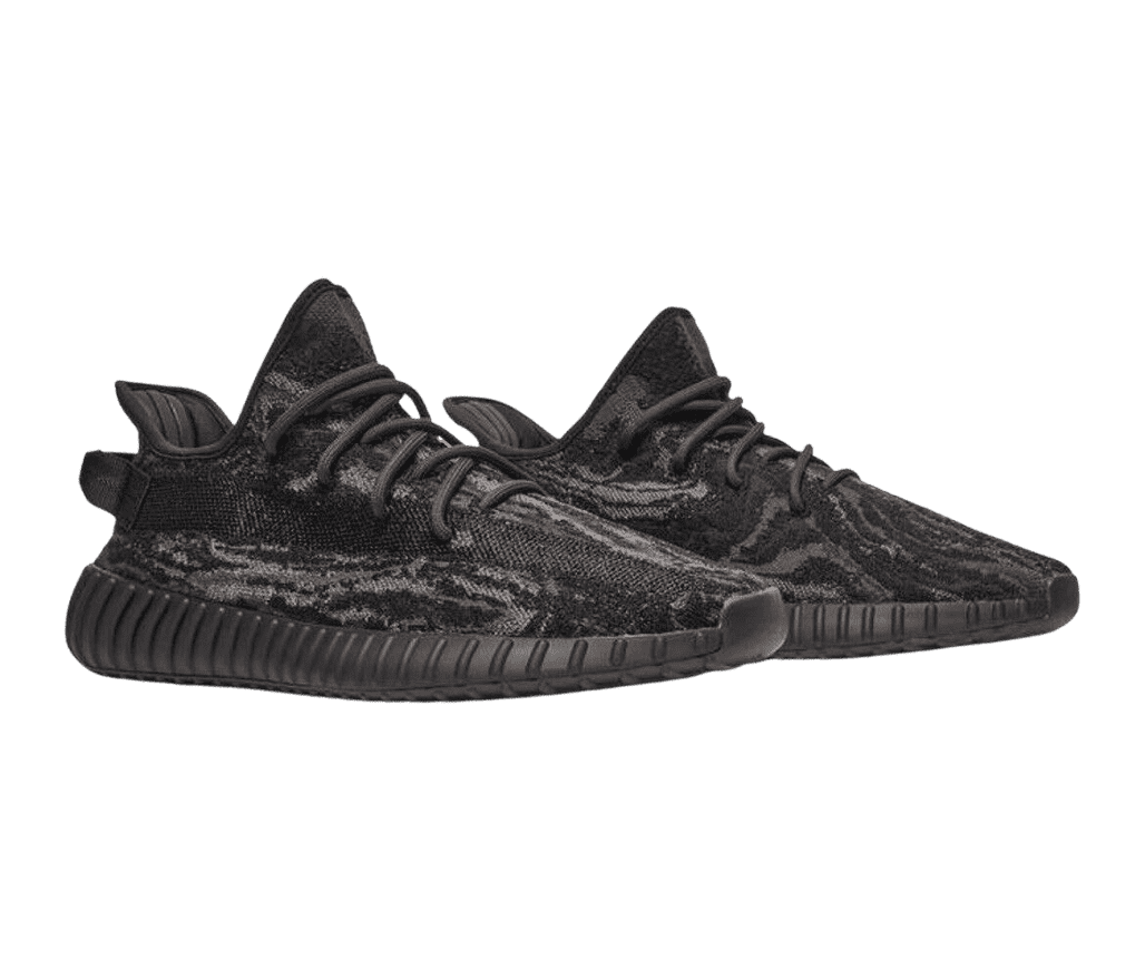 A pair of YEEZY 'MX Rock' sneakers with a brown,
                      black, and gray semi-translucent side and black soles and laces.