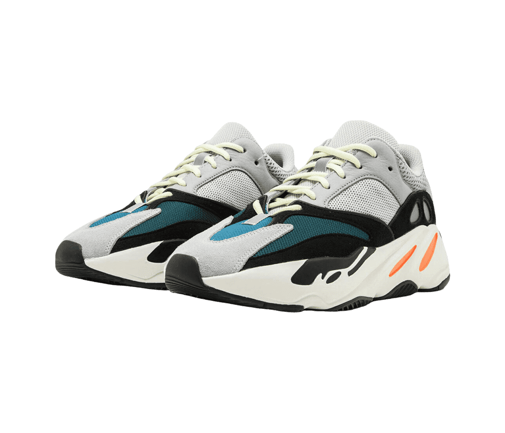 A pair of YEEZY 'Wave Runner' sneakers with a white
                      and orange sole, a gray, blue, and black toe box, and gray collar.