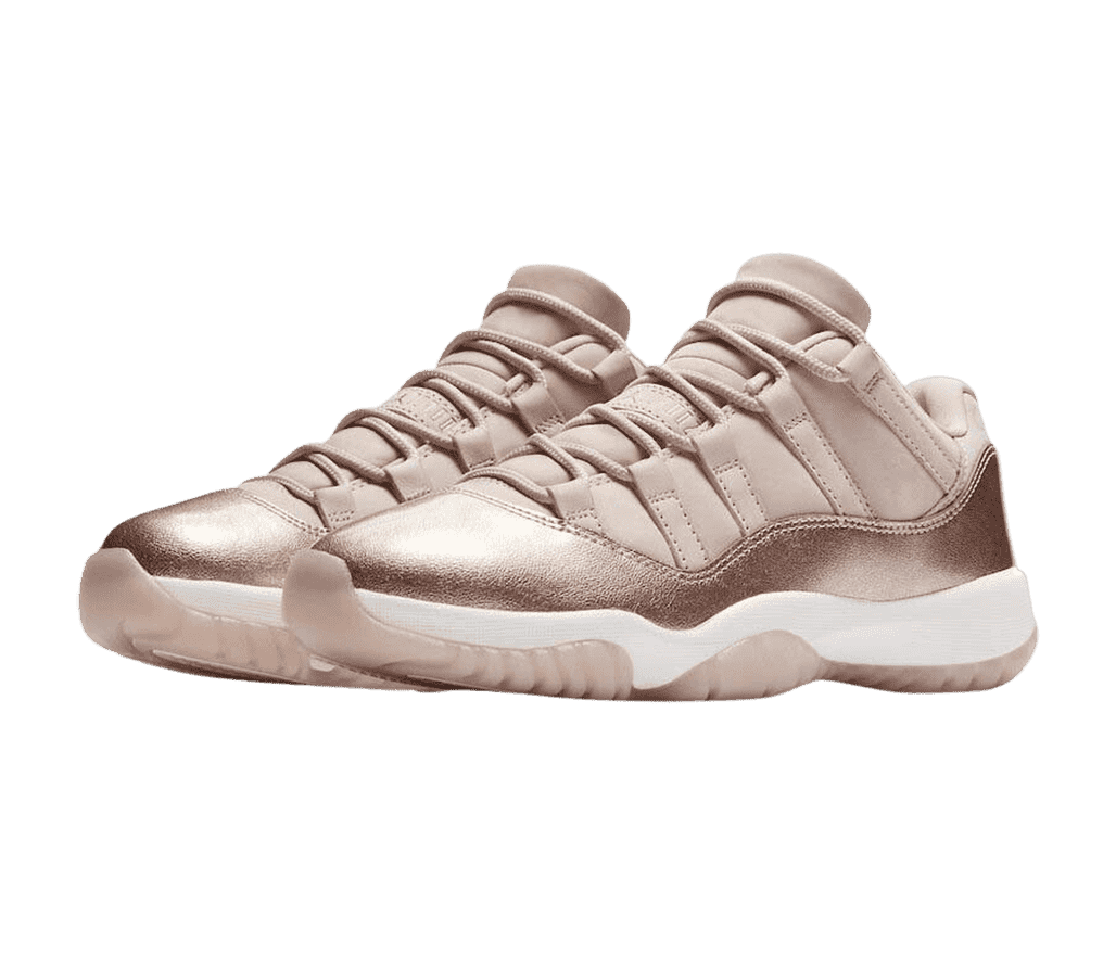 A rose gold pair of AJ11 Low sneakers with a shiny overlay wrapping around the bottom half of the uppers.