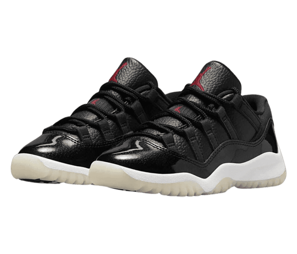 A black pair of AJ11 sneaker with tumbled leather uppers and patent leather overlays.