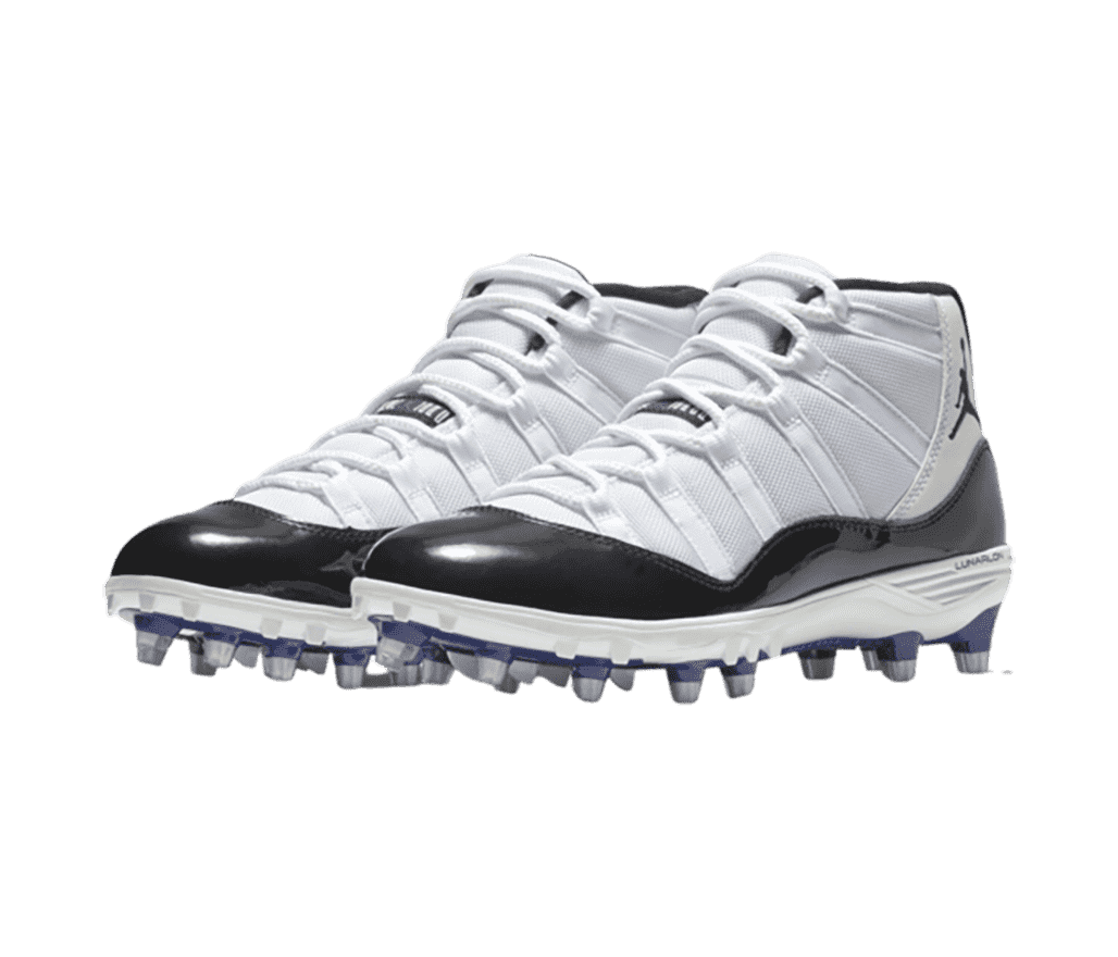 A pair of white AJ11 TD “Concord” sneakers with black patent leather overlays and blue and gray football cleats.