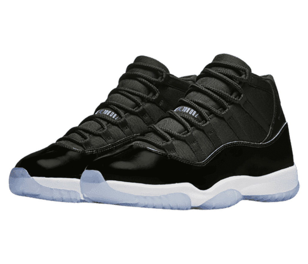 A pair of black AJ11 “Concord” sneakers with black patent leather overlays and light blue translucent outsoles.