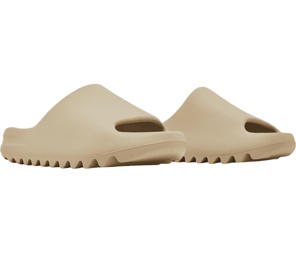 A pair of YEEZY slides in a beige tone made in a one-piece mold made entirely from EVA foam.