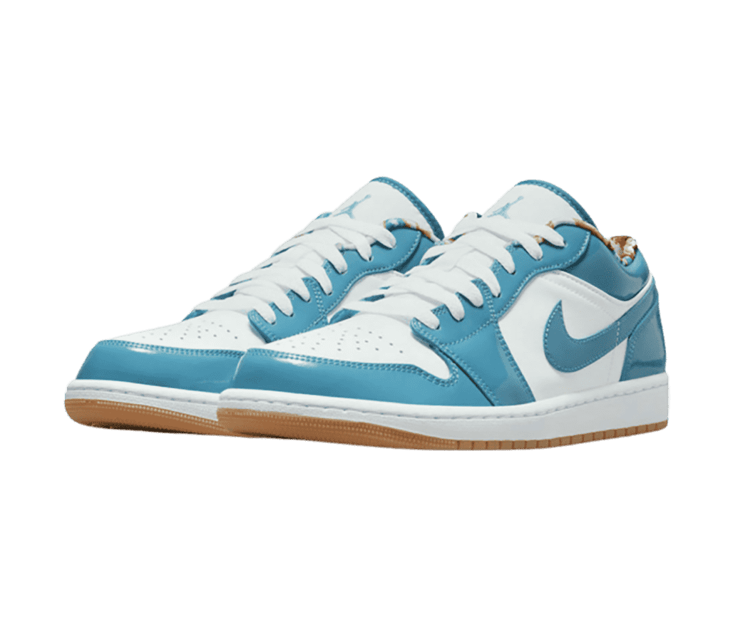 A patent leather pair of AJ1 Low sneakers in white with light blue overlays and gum outsoles.