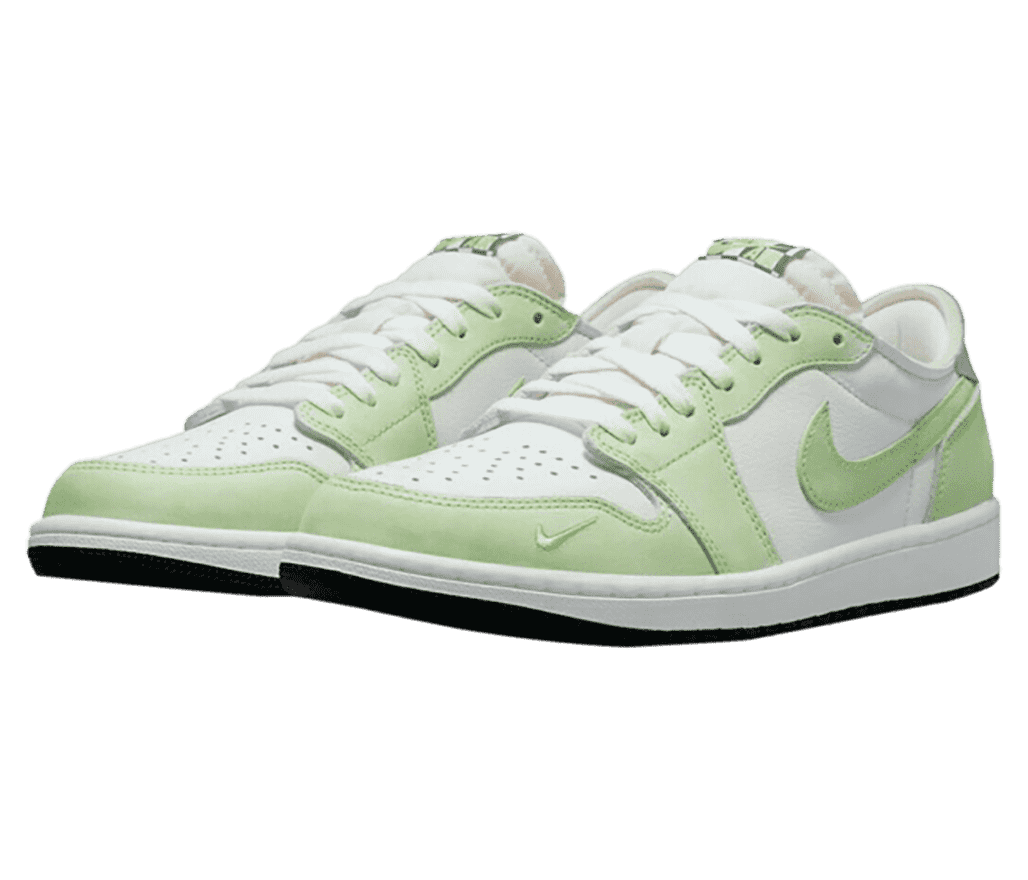 A white pair of AJ1 Low sneakers with lime suede overlays, black outsoles, and a small embroidered Swoosh on the outer toe.