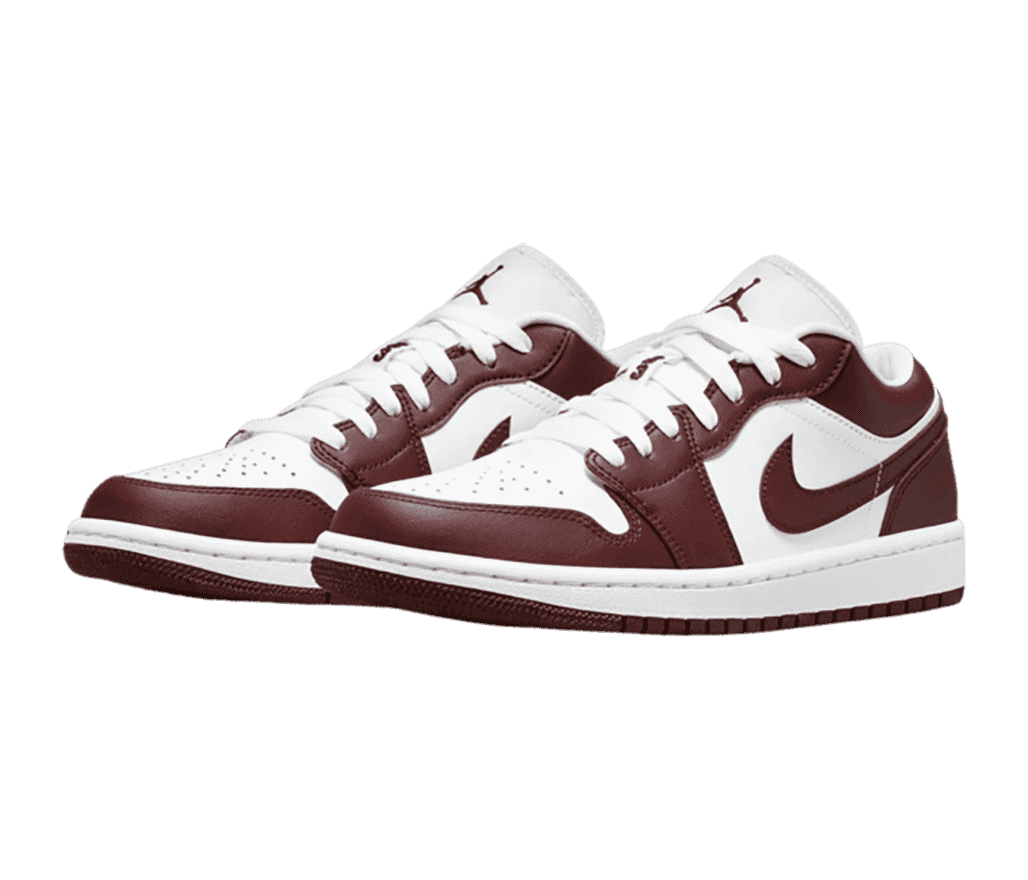 A pair of white leather AJ1 Low sneakers with burgundy outsoles and overlays.