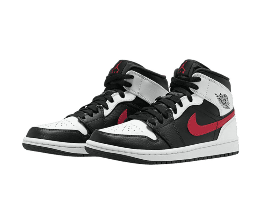 A pair of black and white AJ1 Mid sneakers with tumbled leather overlays and red Swooshes.