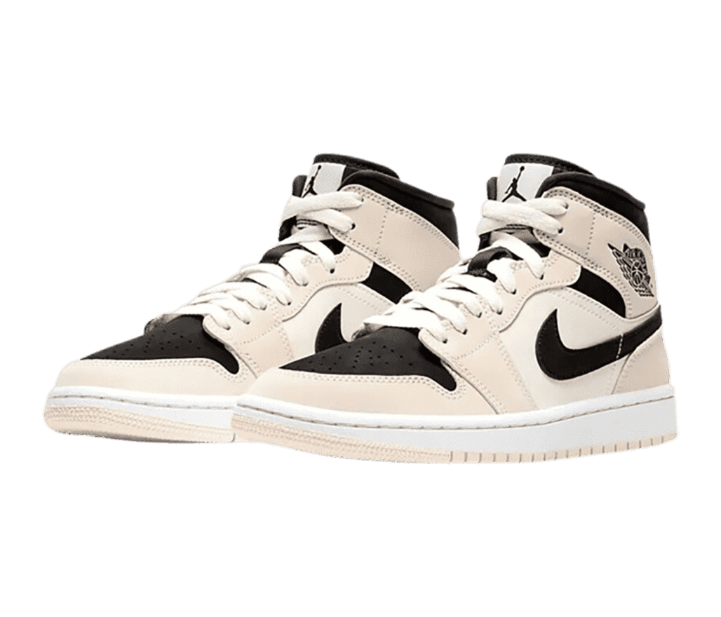 A pair of AJ1 Mid sneakers with deep black toeboxes, Swooshes, and collars with pinkish beige overlays and outsoles.