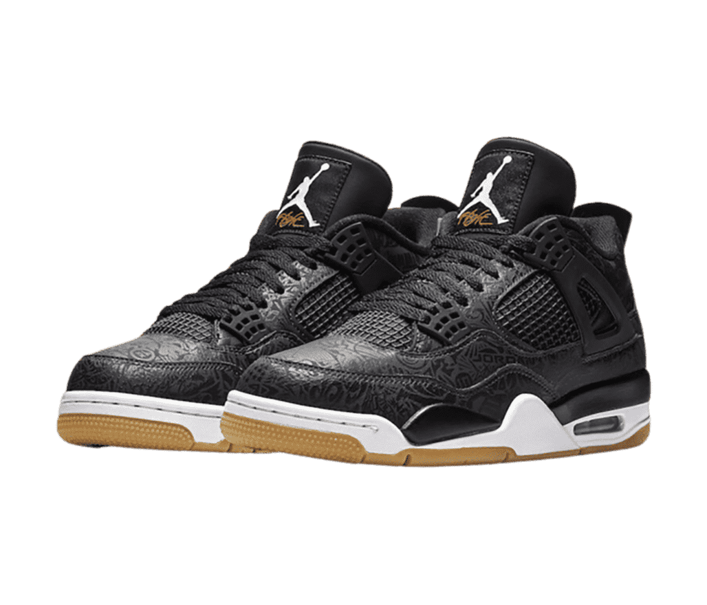 A black pair of AJ4 “Laser” sneakers with white midsoles, gum outsoles, and intricate graphics all over the shoe.
