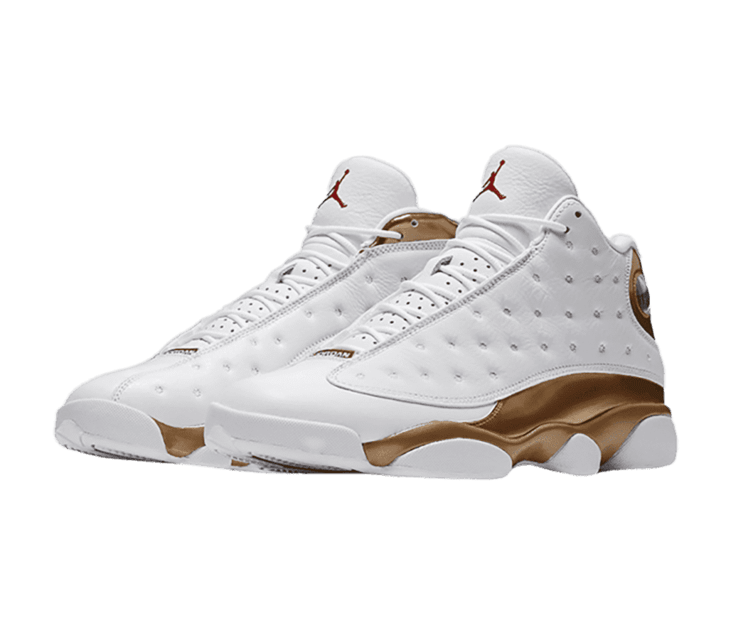 A white pair of AJ13 sneakers with brown patent leather quarters and collars.