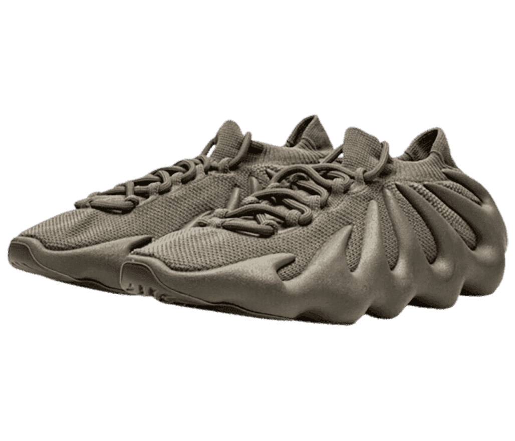 A dark tan pair of Yeezy 450 “Cinder” sneakers that have rubber soles with a wavy design reaching the collar of the shoe.